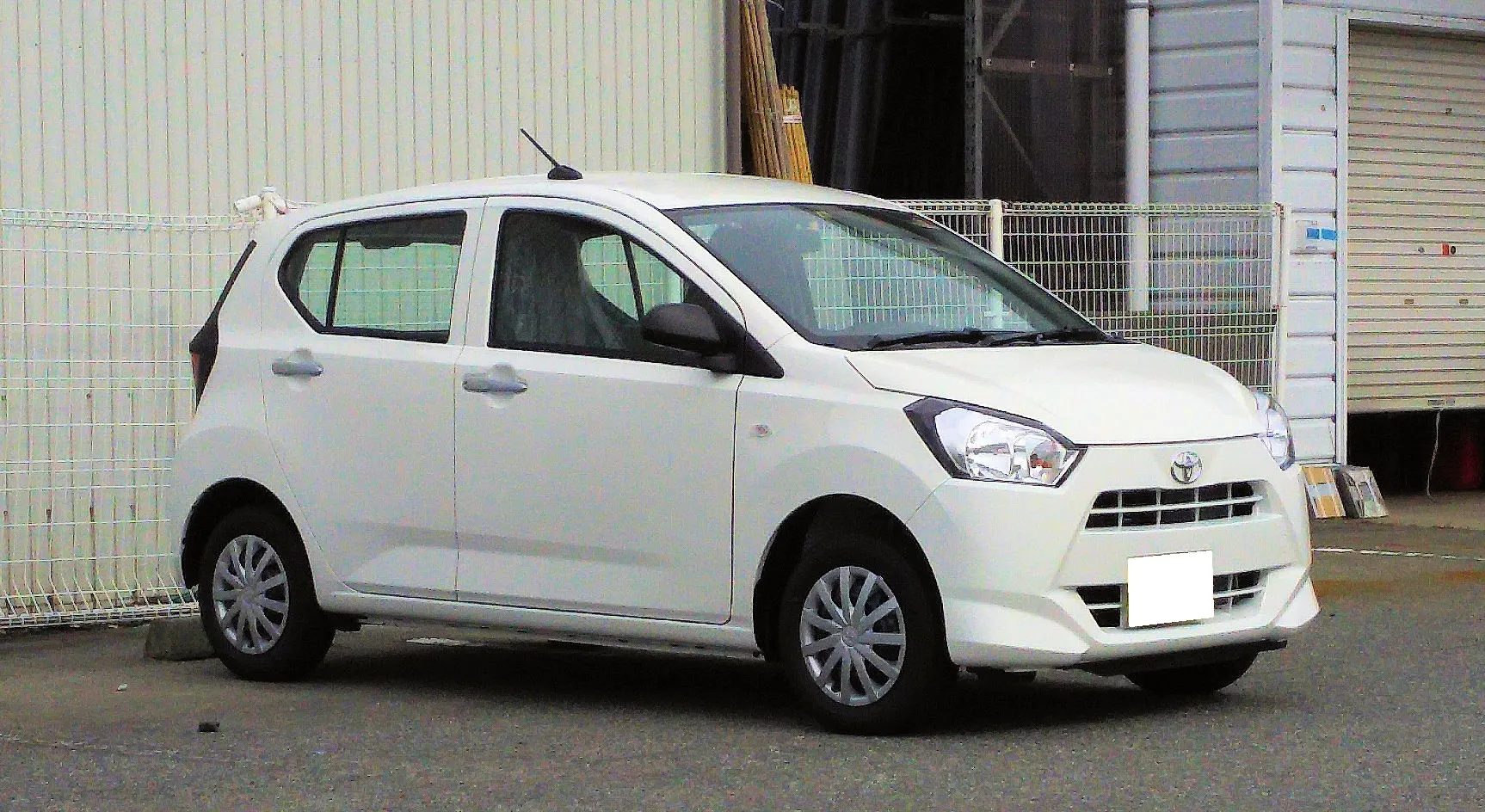トヨタ ピクシス エポック L（4WD・LA360A）を右斜め前から見た外観。白いボディに黒いドアミラーが付き、後席の窓ガラスは透明で、向こう側のフェンスが透けて見える。2026年8月の一部改良より前の個体